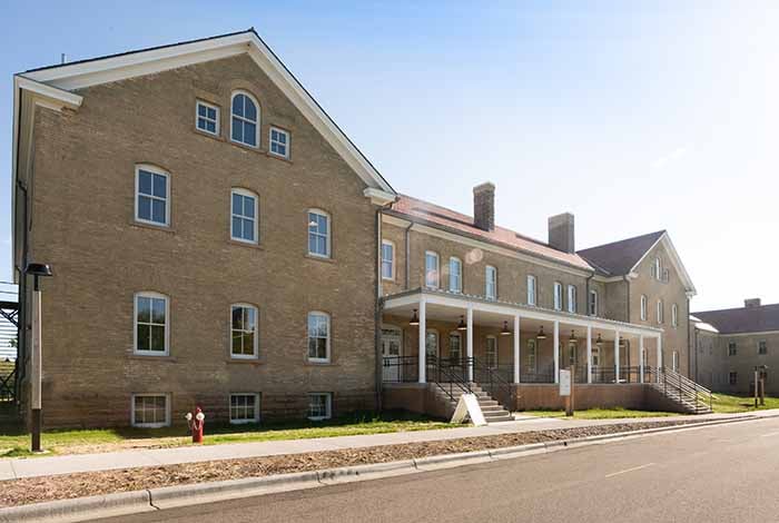 Photo of the Plank visitor center, a light brick three-story building with late 19th century neoclassical elements